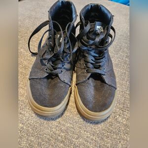 Vans high top black gum soles.